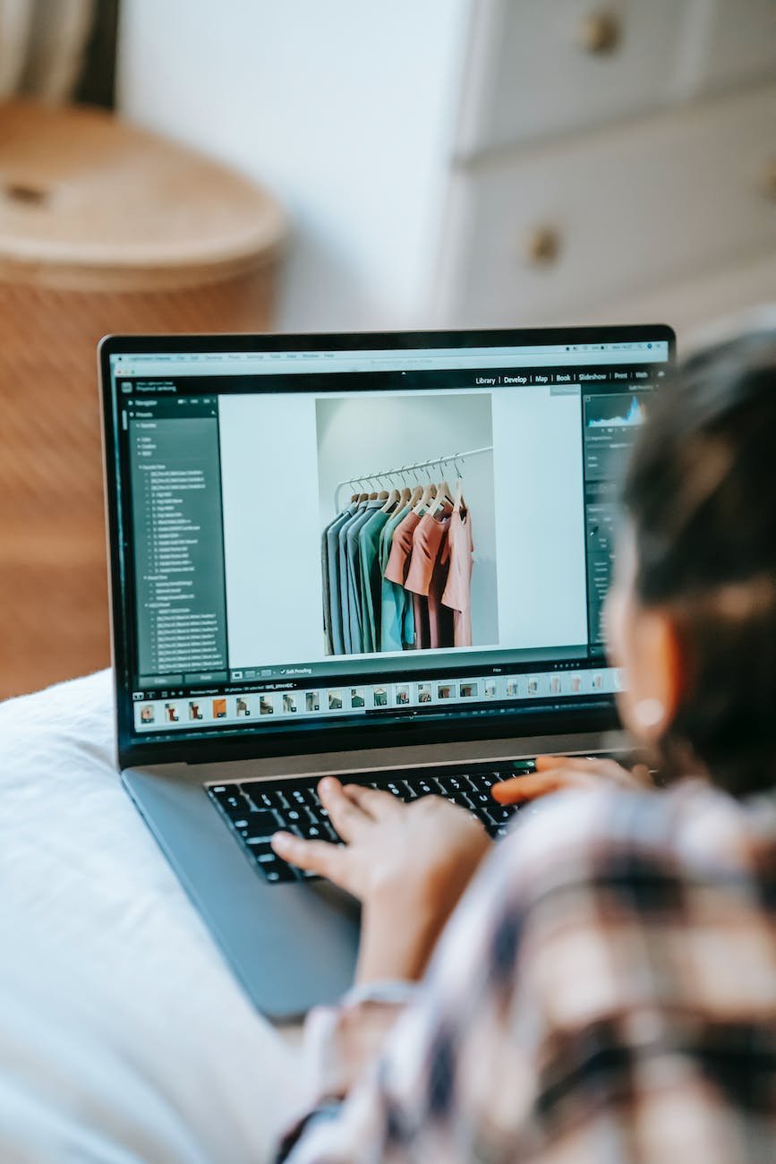 crop freelancer retouching photography on laptop at home